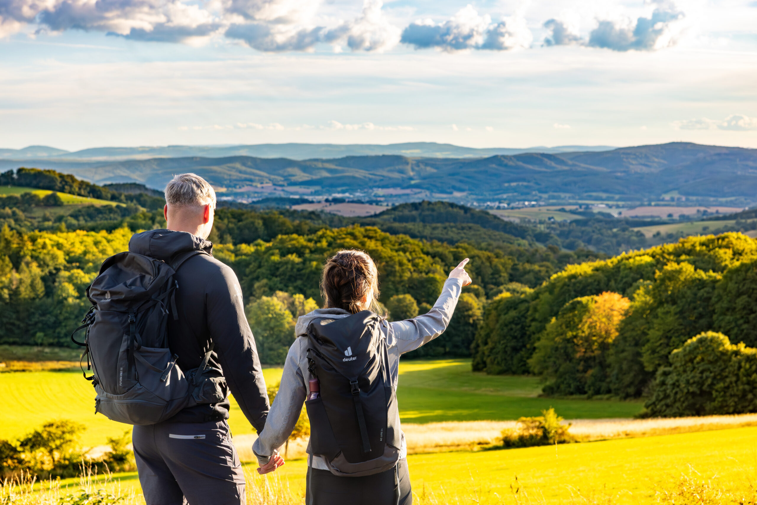 Paar zeigt in die Ferne beim Wandern an der Hohen Klinge.